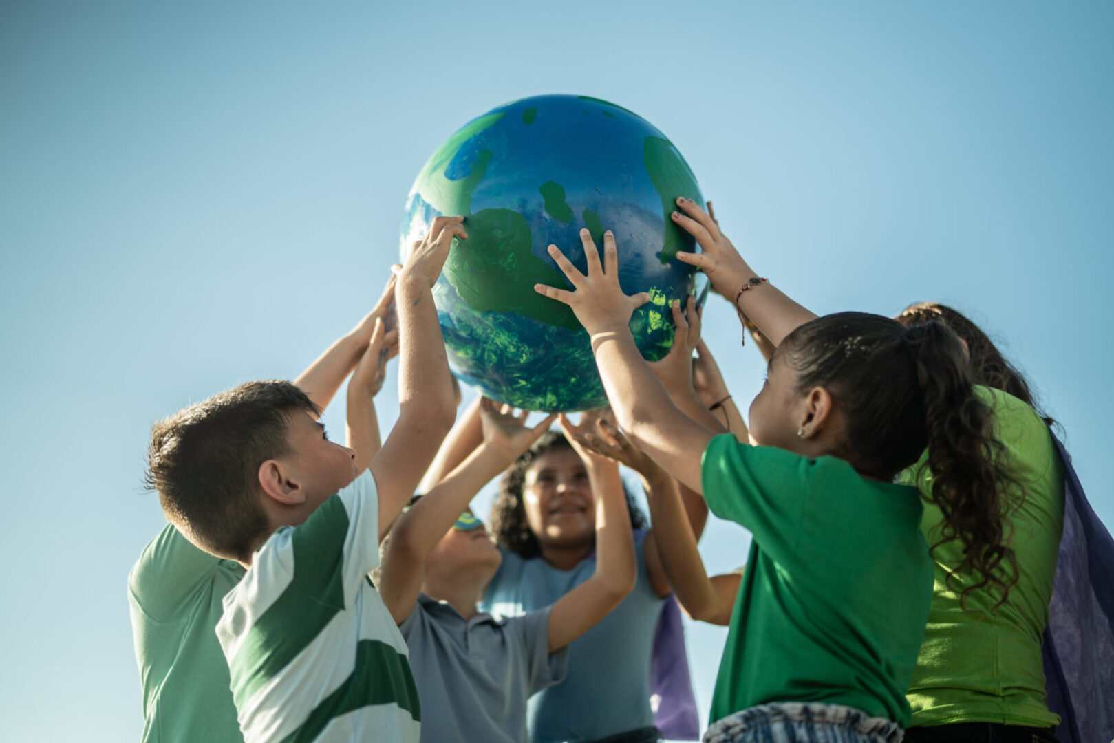 A group of children holding onto a large ball